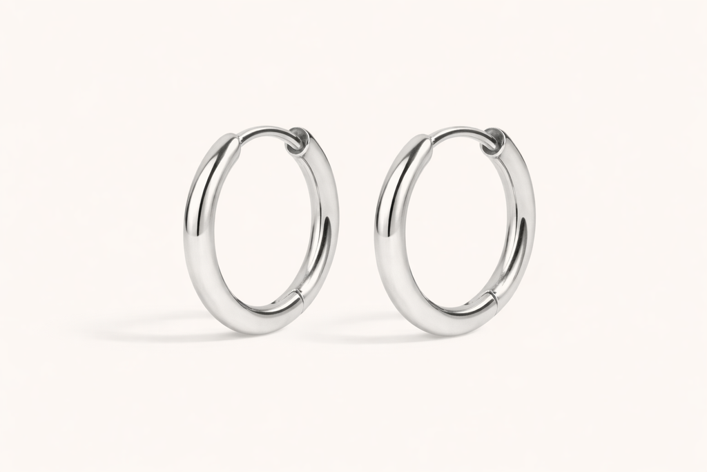 Pair of silver hoop earrings on a white background