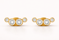 Pair of gold earrings with cz diamonds on a white background