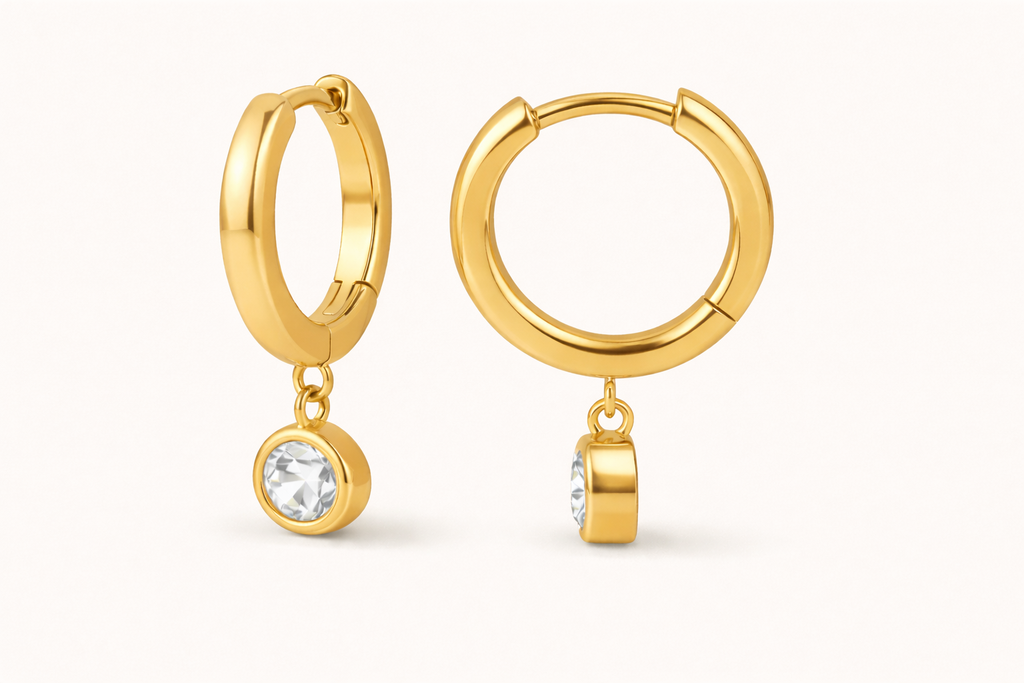 Gold hoop earrings with small drop diamond on a white background