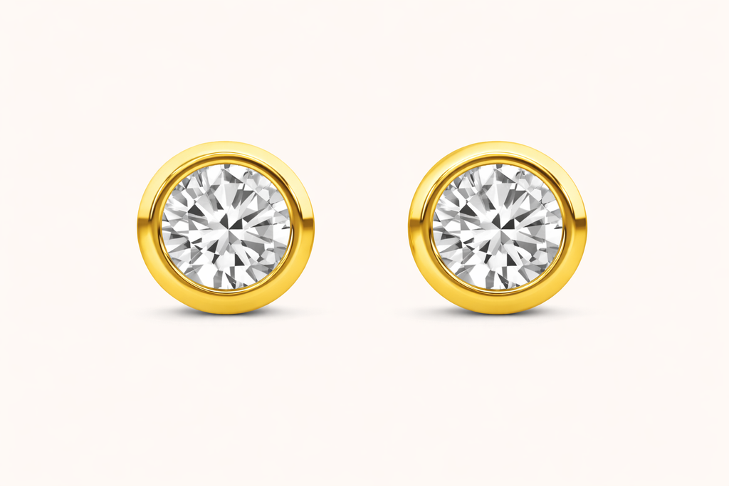 Bezeled diamond earrings on a white background