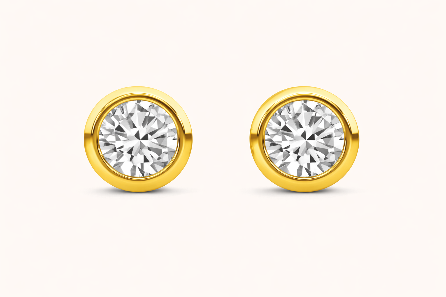 Bezeled diamond earrings on a white background