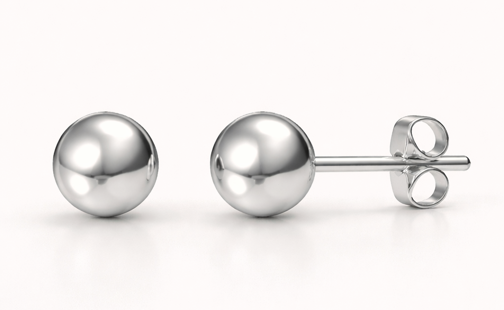 Pair of silver ball earrings on a white background