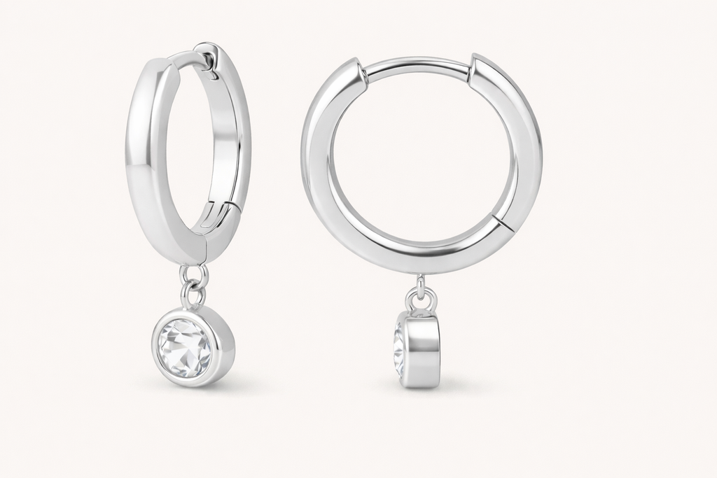 Silver hoop earrings with small drop diamond on a white background